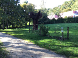Gemüsebeet in Park neben künstlerischen Statue